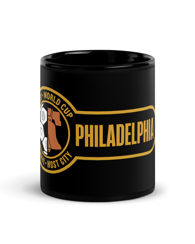Liberty Protocol Philly '26 Mug — Black Glossy 11oz, front view of Liberty Bell and soccer ball crest