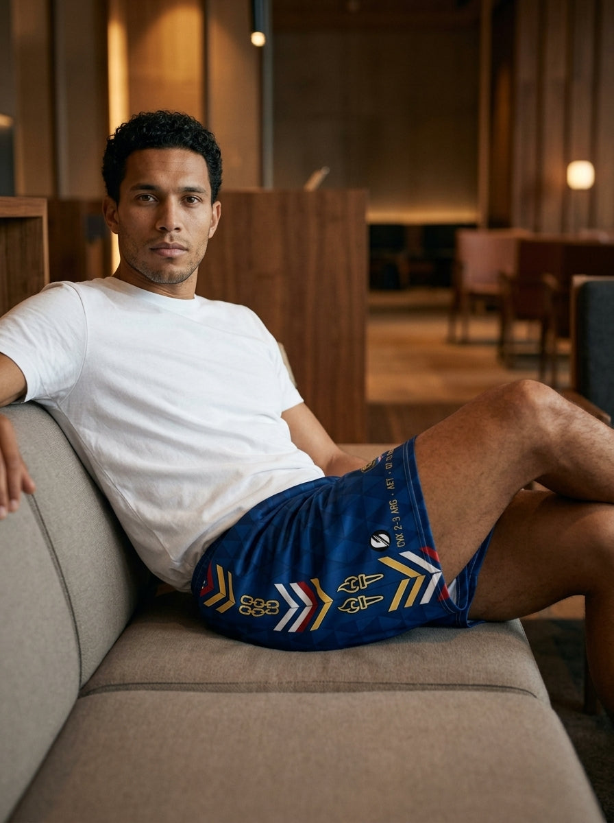 Cabo Verde '26 Blue Shark Protocol Shorts — lifestyle lounge shot, SunBorn