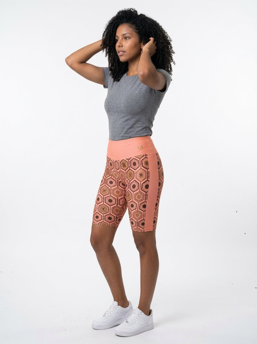 AnanseNova™ Biker Shorts in Adaeze Pink, three-quarter left view on model — SunBorn