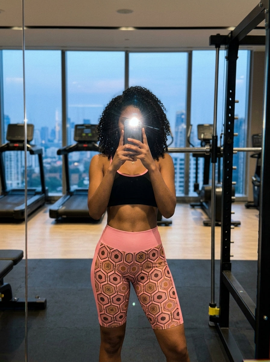 AnanseNova™ Biker Shorts in Adaeze Pink, gym mirror selfie with city skyline view — SunBorn