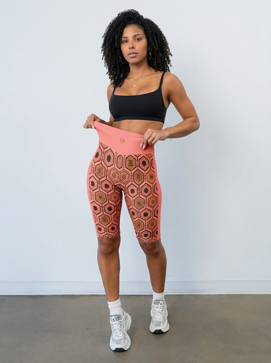 AnanseNova™ Biker Shorts in Adaeze Pink styled with a black sports bra, full-length studio view — SunBorn