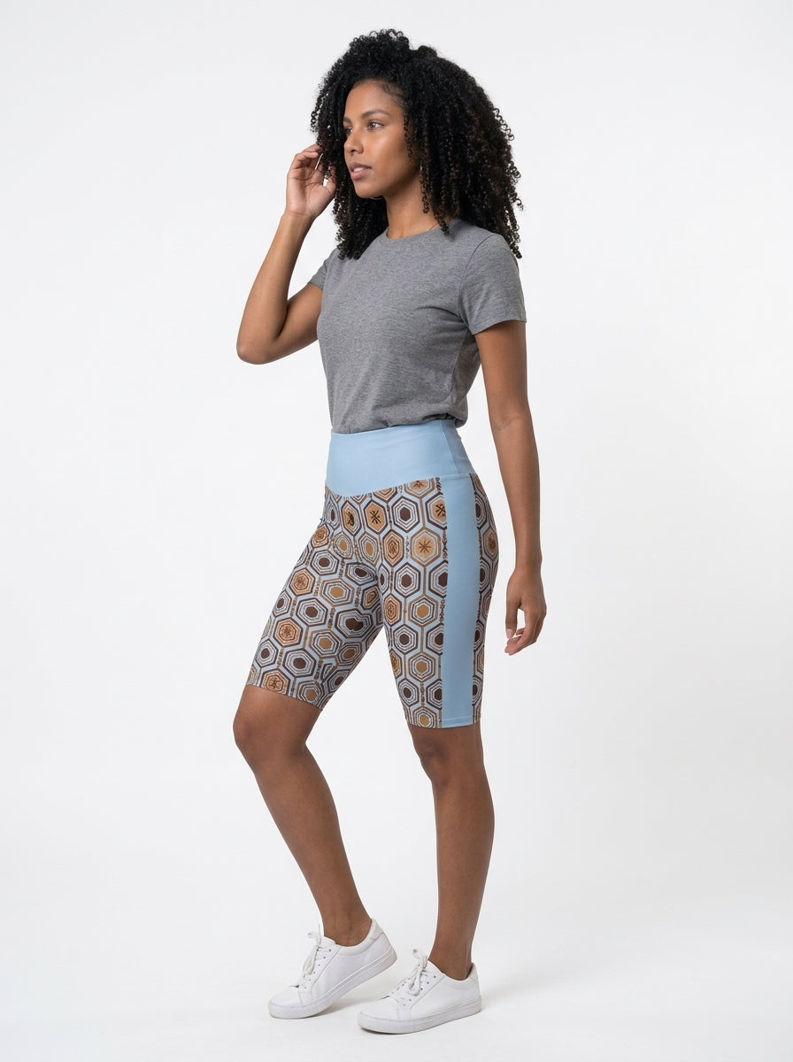AnanseNova™ Biker Shorts in Igwe Blue, three-quarter left view on model — SunBorn