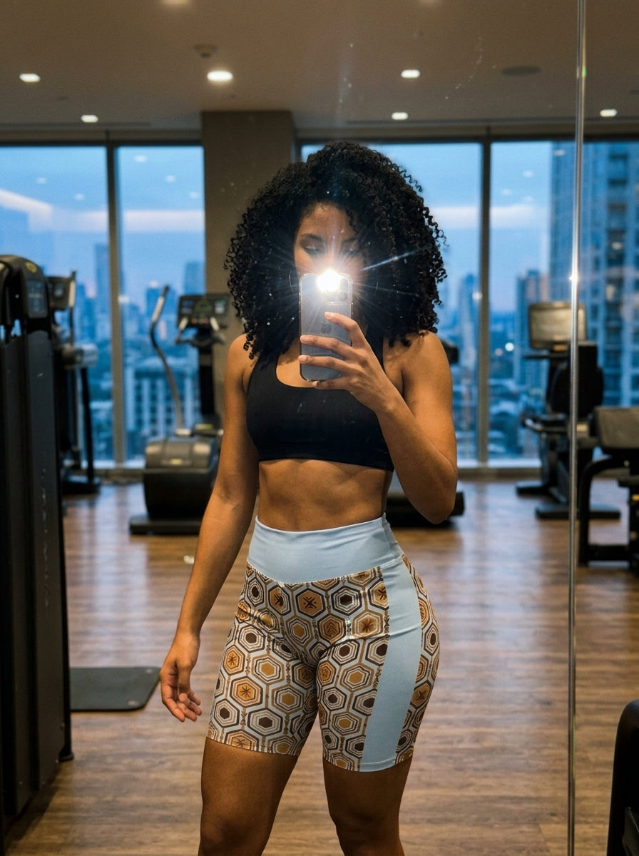 AnanseNova™ Biker Shorts in Igwe Blue, gym mirror selfie with city skyline view — SunBorn