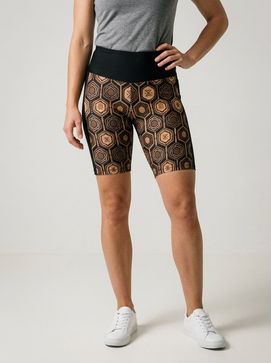 AnanseNova™ Biker Shorts in Oji Black with hexagon web-cell print, studio front view — SunBorn