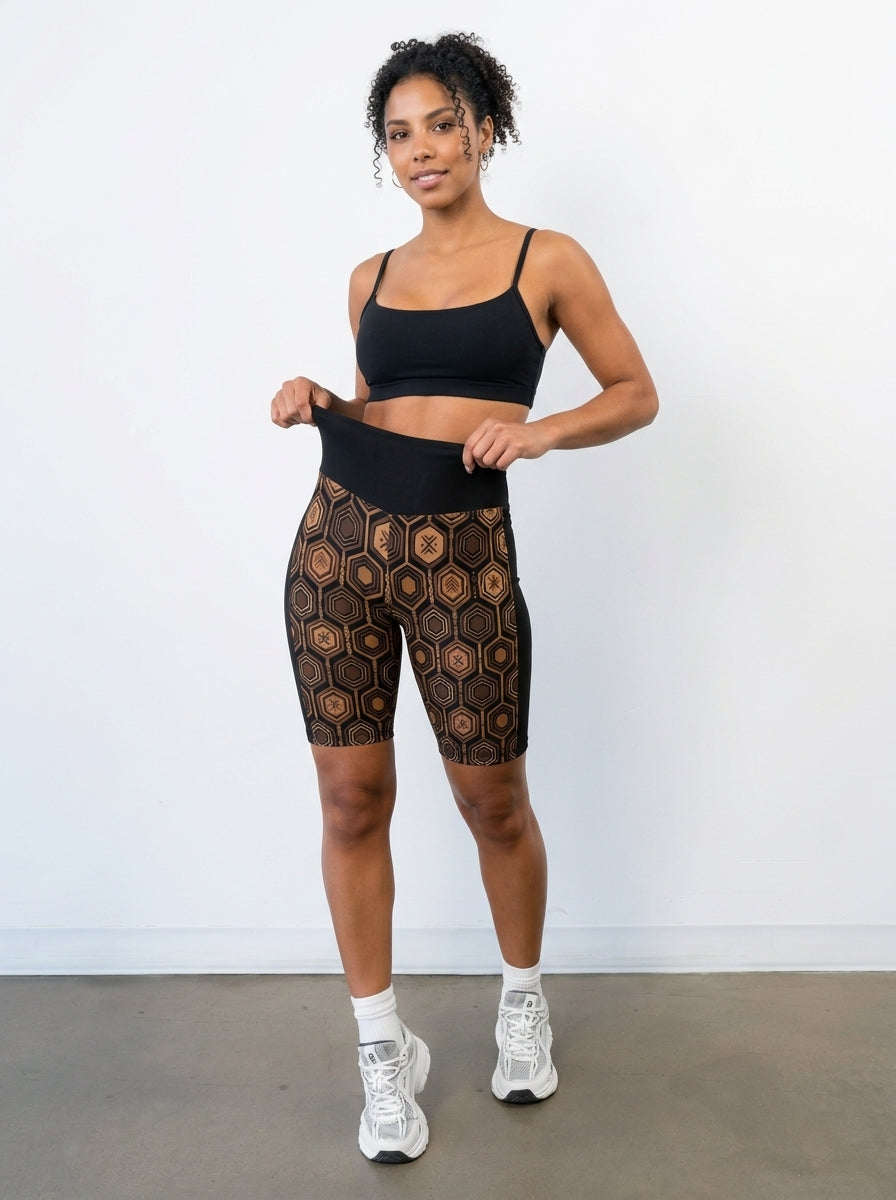 AnanseNova™ Biker Shorts in Oji Black styled with a matching top, full-length studio view — SunBorn