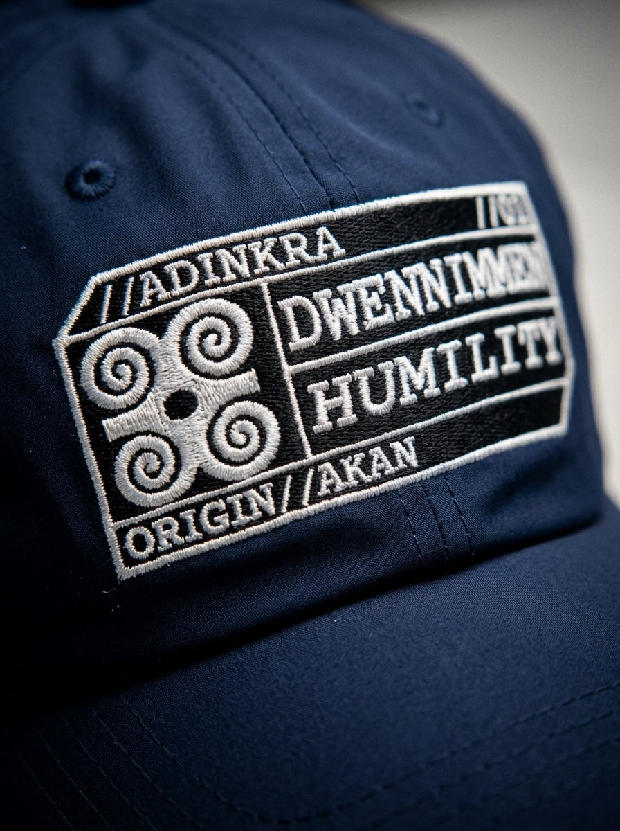 Adinkra Humility Dad Hat in Anụnụ Blue — macro detail of embroidered Dwennimmen glyph badge