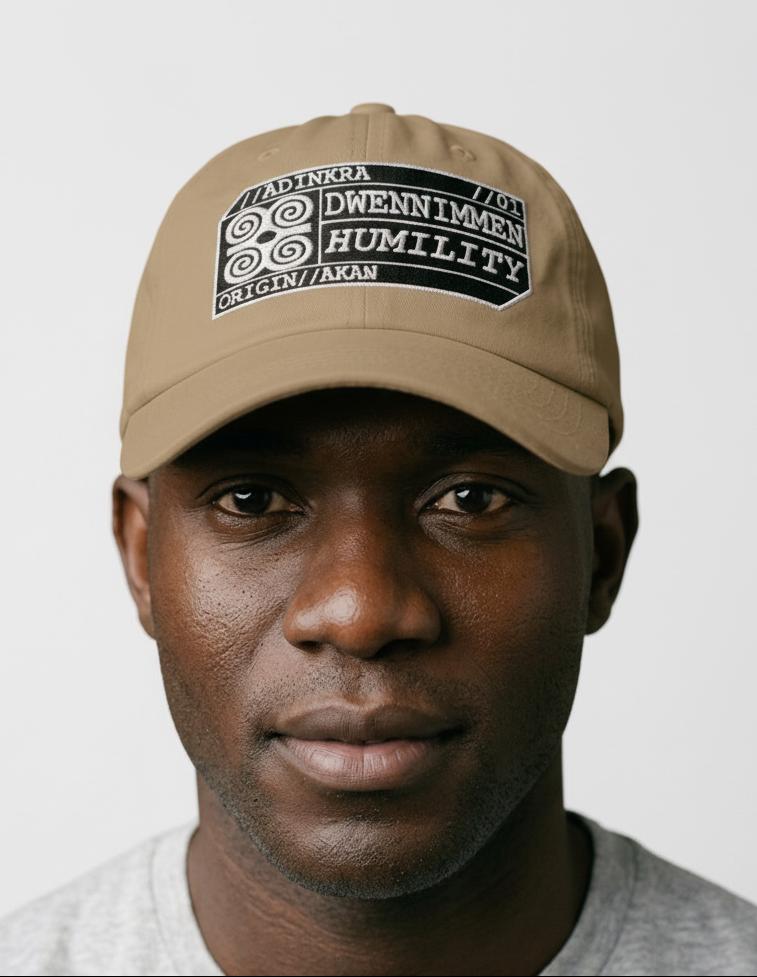 Adinkra Humility Dad Hat in Aja Sand — worn front view, embroidered Dwennimmen badge