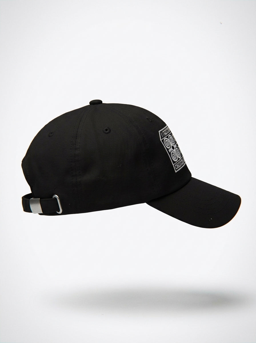Adinkra Humility Dad Hat in Oji Black — side profile, curved brim
