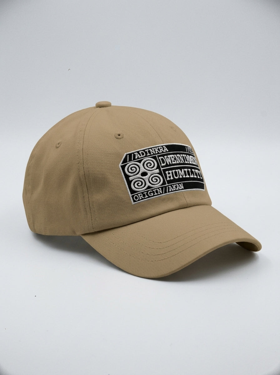 Adinkra Humility Dad Hat in Aja Sand — three-quarter left angle