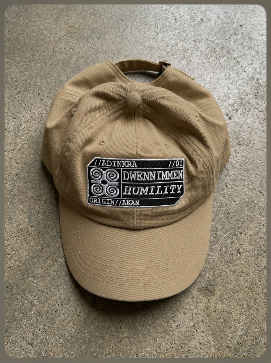 Adinkra Humility Dad Hat in Aja Sand — styled flat lay