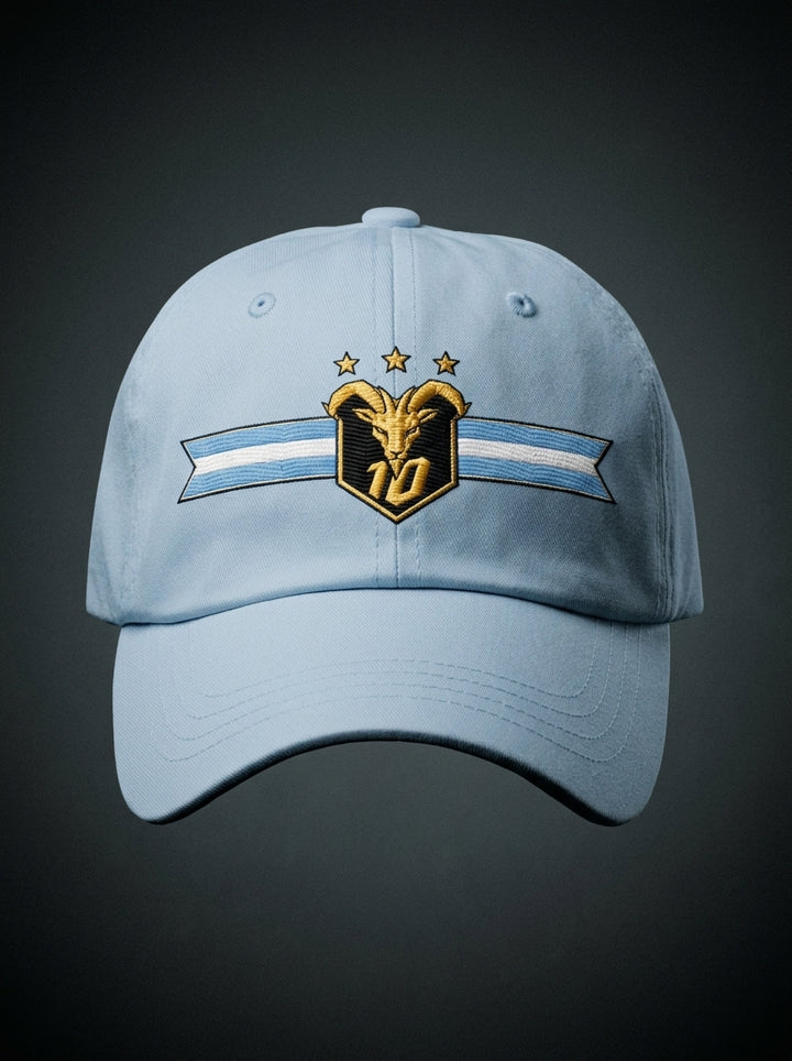 GOAT Celeste Dad Hat in Igwe Blue, front view — gold goat crest with N°10 and three stars on an Albiceleste ribbon.