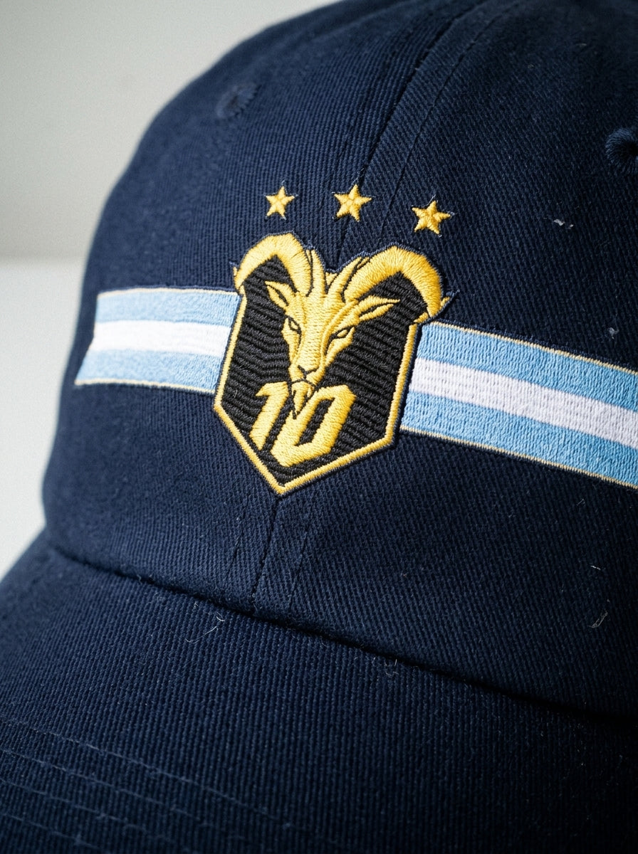 GOAT Celeste Dad Hat in Anụnụ Blue, close-up of the embroidered gold goat crest with N°10 and three stars.