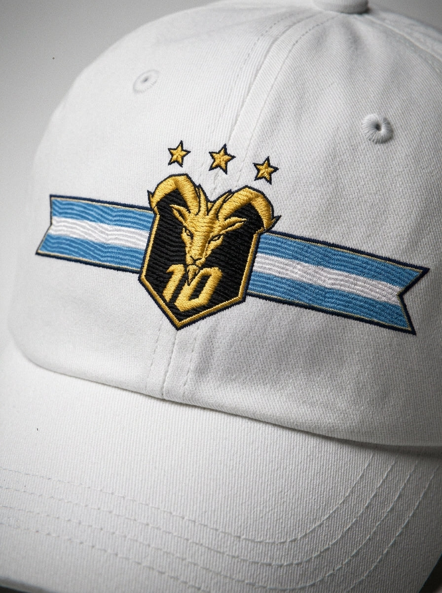 GOAT Celeste Dad Hat in Ocha White, close-up of the embroidered gold goat crest with N°10 and three stars.