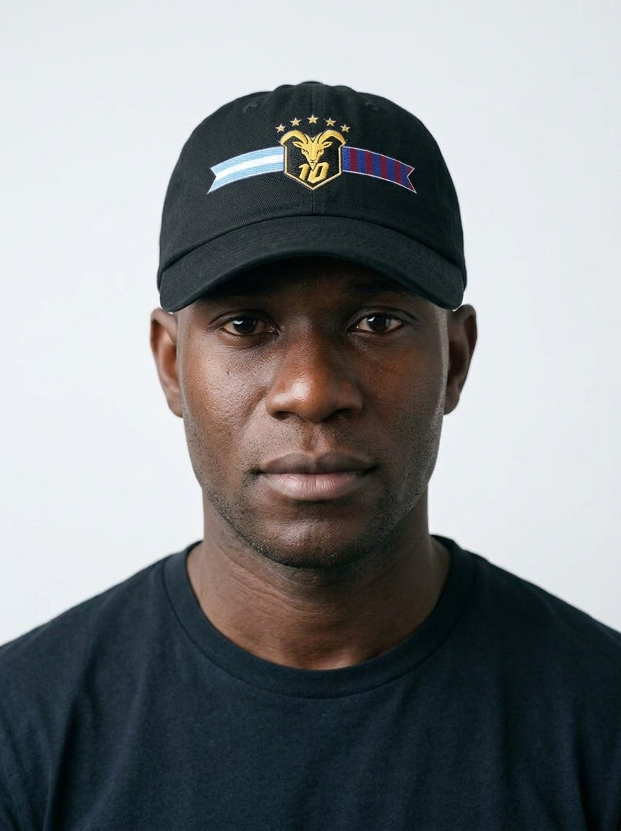GOAT Fusión dad hat in Oji Black, worn — the both-flags GOAT crest front and centre