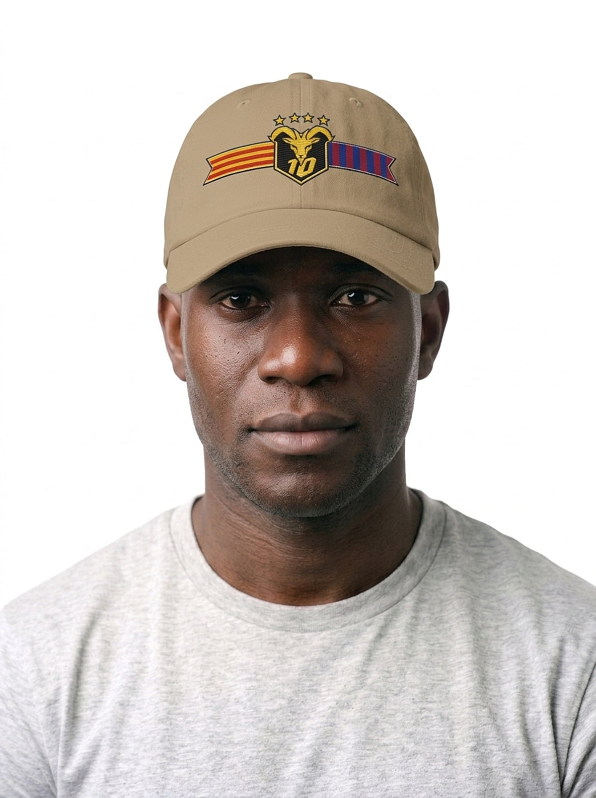 Model wearing the GOAT Catalan dad hat in Aja Sand, front view, showing the embroidered Catalan crest on the low-profile crown.