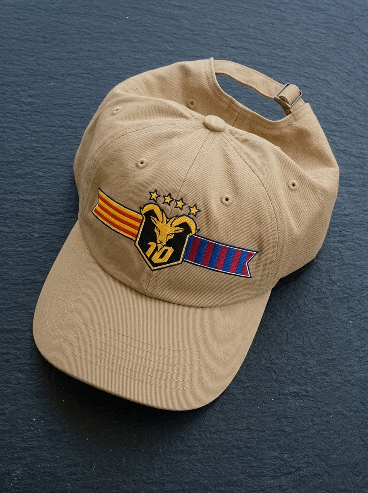 GOAT Catalan dad hat in Aja Sand, styled flat-lay showing the embroidered Catalan crest.