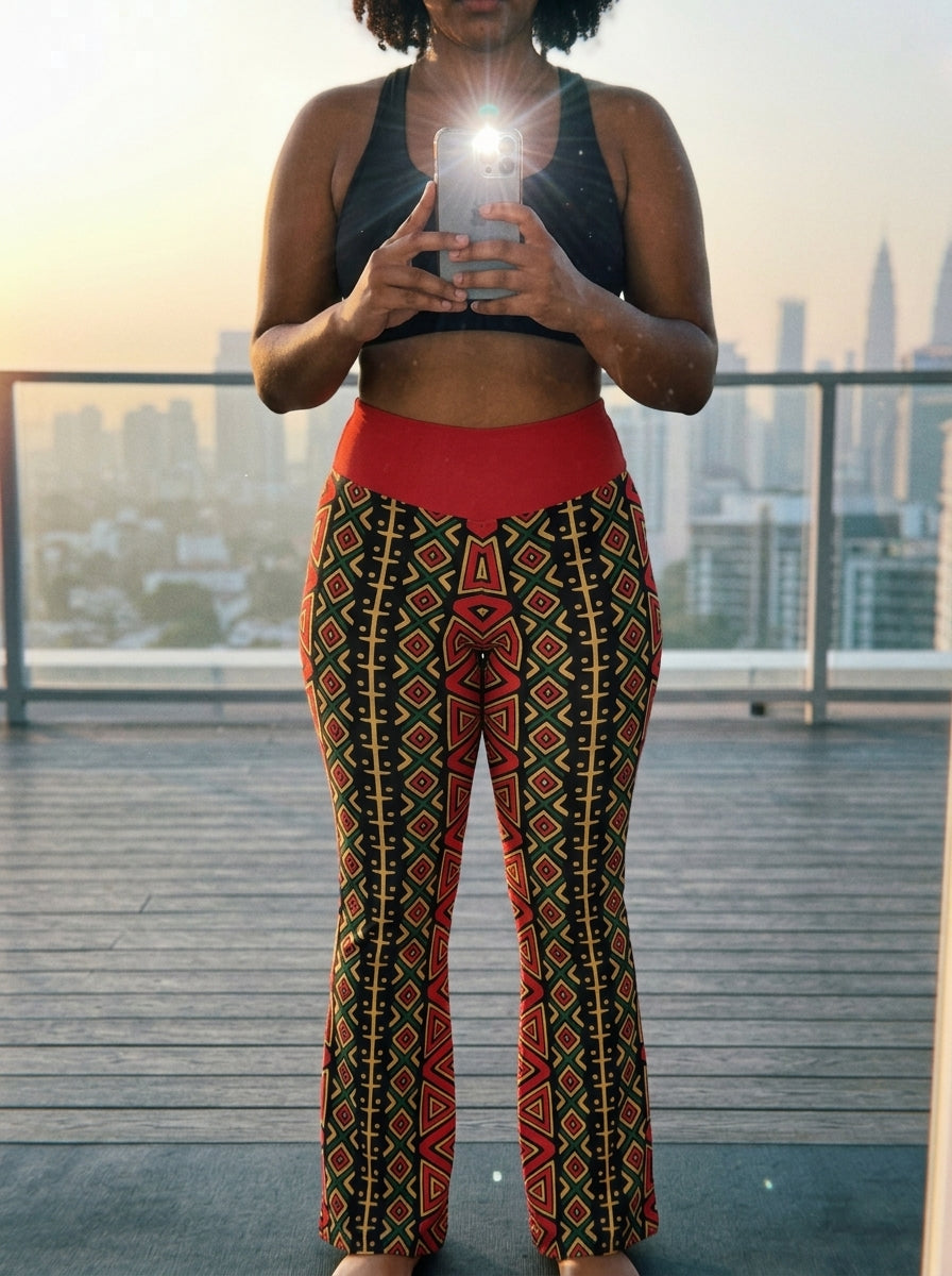 Model in the N'Donso™ Flare Leggings (Uhie Red), lifestyle mirror selfie at a pilates studio.