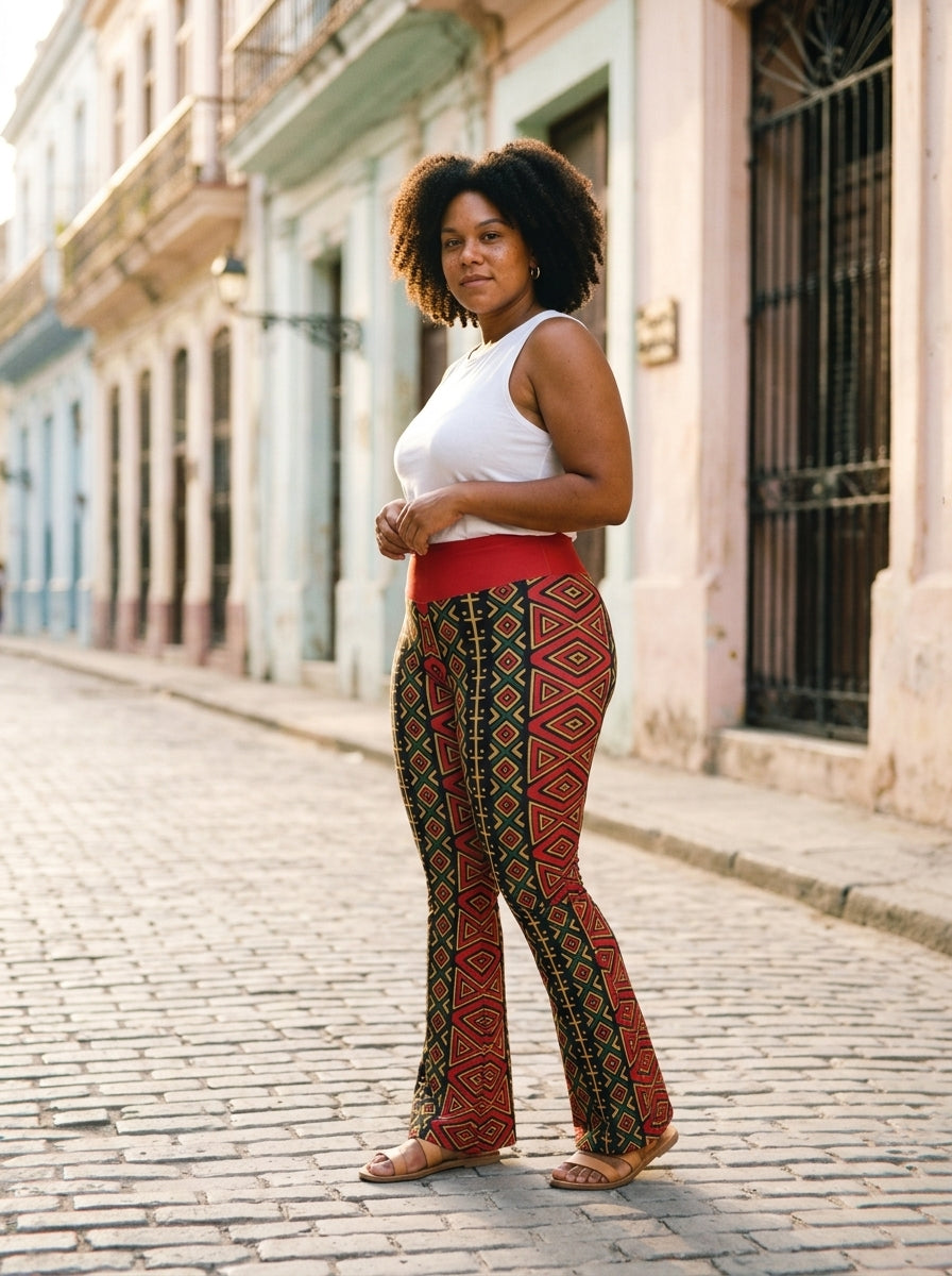 Model wearing the N'Donso™ Flare Leggings in Uhie Red, editorial lifestyle shot.