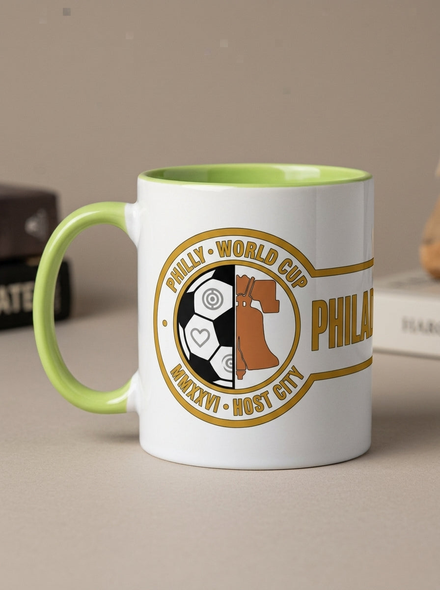 Liberty Protocol Philly '26 Mug — White Ceramic with Lime interior, steaming on a sunlit desk beside a laptop