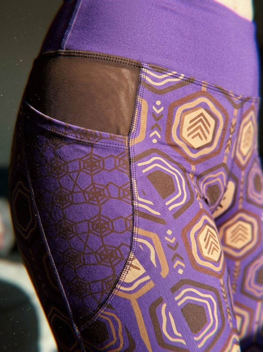 Close-up of the Ugo Purple hexagon web-cell print and seam on the AnanseNova™ Pocket Leggings