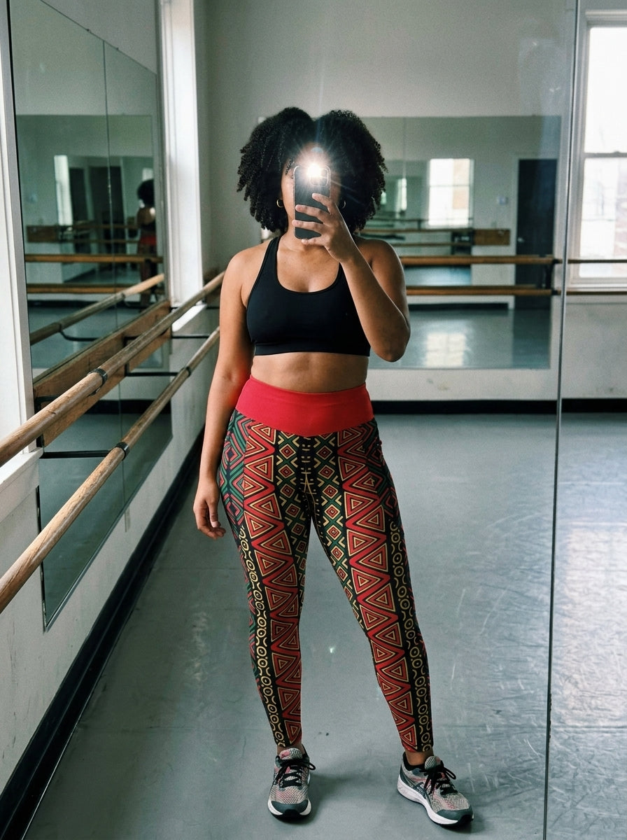 Model in the N'Donso™ Pocket Leggings (Uhie Red), lifestyle mirror selfie at a pilates studio.