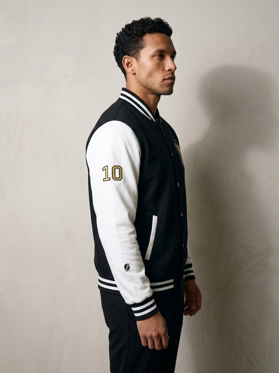 GOAT // Fusión Letterman Jacket in Jet Black/Arctic White, three-quarter right