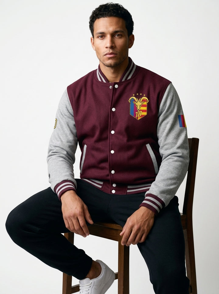 GOAT // Catalan Letterman Jacket in burgundy and heather grey, front view — gold Senyera crest on the left chest.
