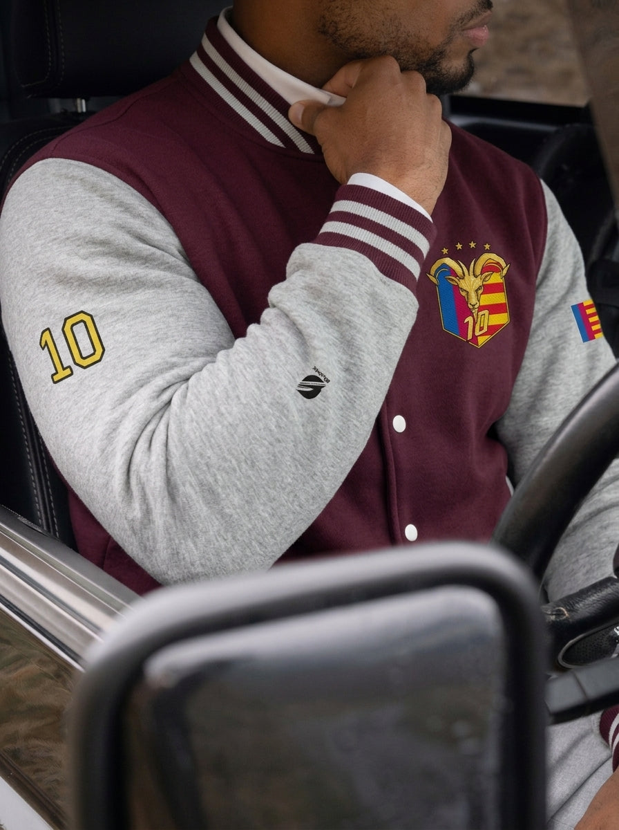Model wearing the GOAT // Catalan Letterman Jacket in burgundy, editorial lifestyle shot.