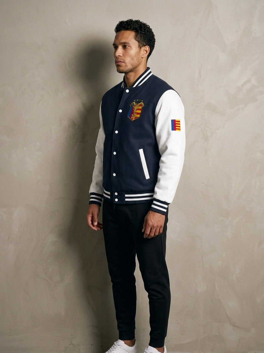 GOAT // Catalan Letterman Jacket in oxford navy, three-quarter left view.