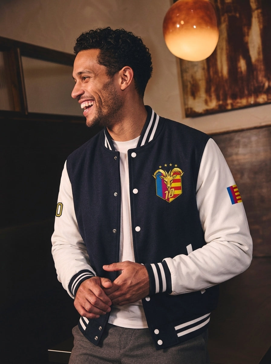 Model wearing the GOAT // Catalan Letterman Jacket in oxford navy, editorial lifestyle shot.