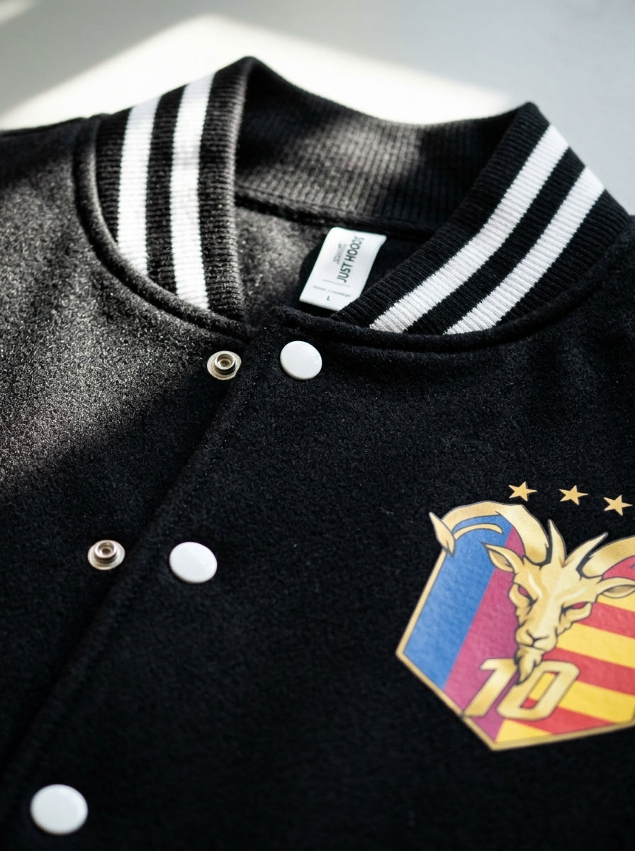 Close-up of the snap buttons and ribbed trim on the GOAT // Catalan Letterman Jacket in jet black.