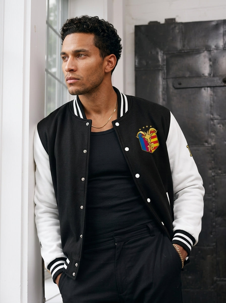 Model wearing the GOAT // Catalan Letterman Jacket in jet black, editorial lifestyle shot.