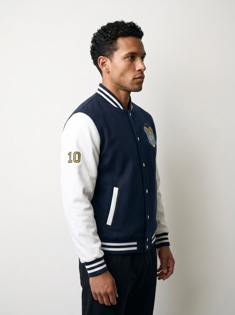 GOAT // Celeste Letterman Jacket in Oxford Navy / Arctic White, three-quarter right.