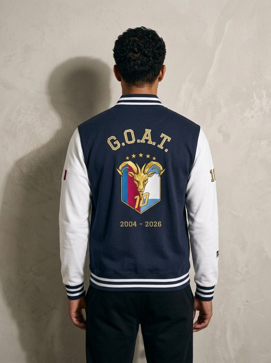 Back of the GOAT // Fusión Letterman Jacket in Oxford Navy/Arctic White — arched G.O.A.T. over the full-colour crest, 2004–2026