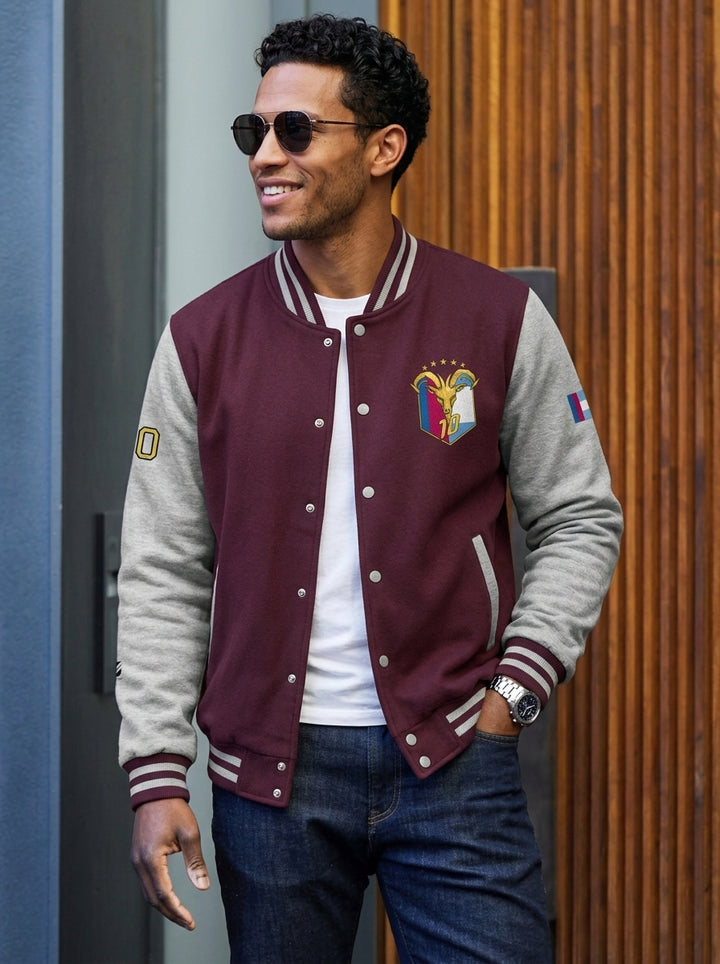 GOAT // Fusión Letterman Jacket in Burgundy/Heather Grey — lifestyle shot, both-flags crest on AkomaDrive™ varsity