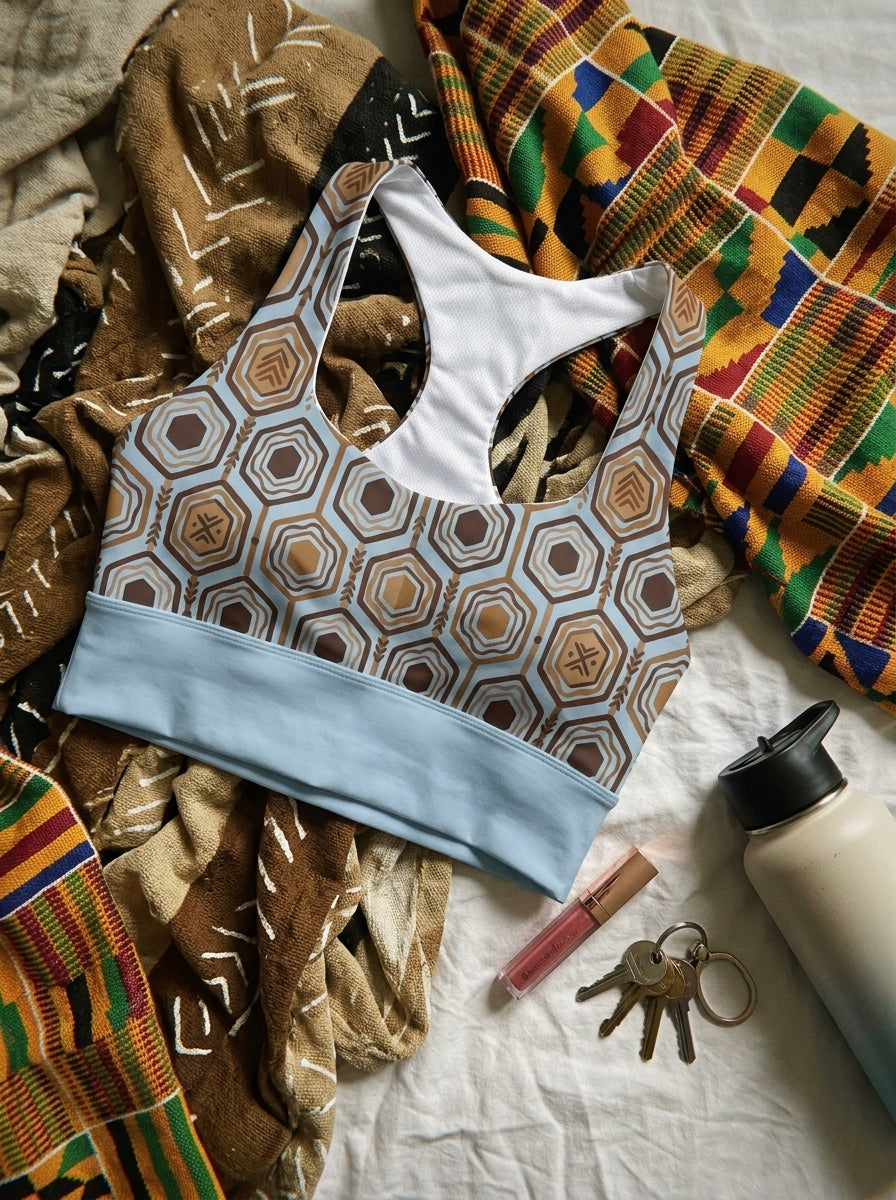 AnanseNova™ Longline Sports Bra in Igwe Blue™, styled flat lay — SunBorn