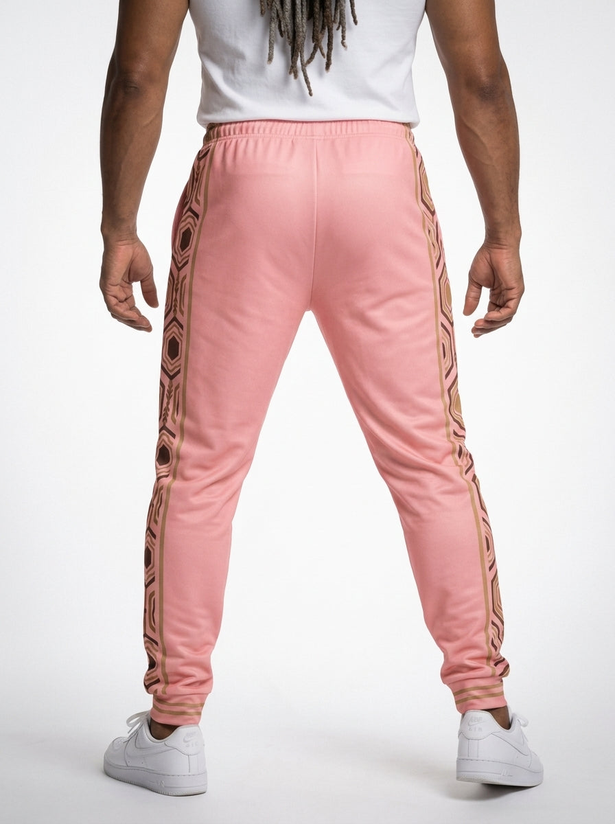 AnanseNova™ Men's Joggers in Eze Pink, back view on model — hexagon side panels running waist to cuff, slim athletic fit. SunBorn