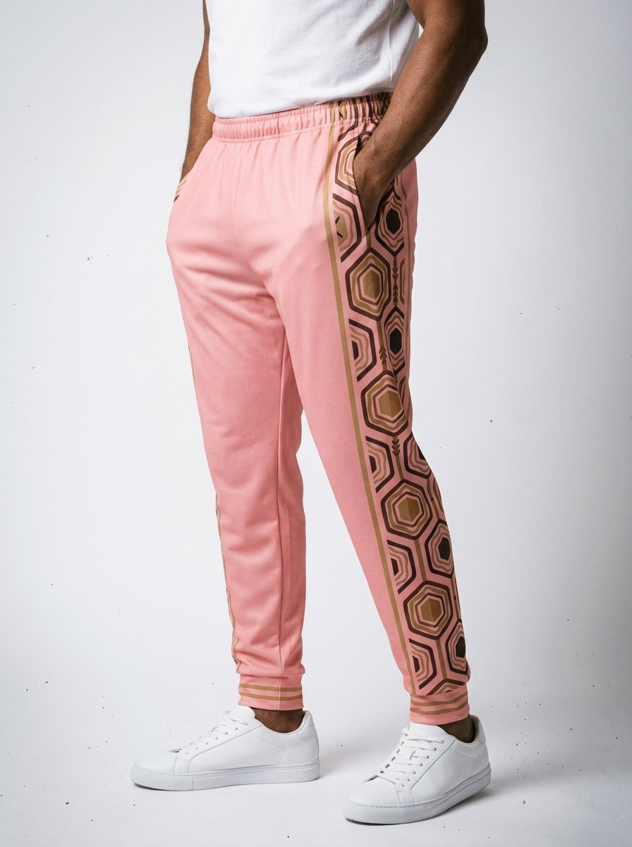 AnanseNova™ Men's Joggers in Eze Pink, three-quarter left view on model — hexagon web-cell side panel with bronze pinstripe. SunBorn