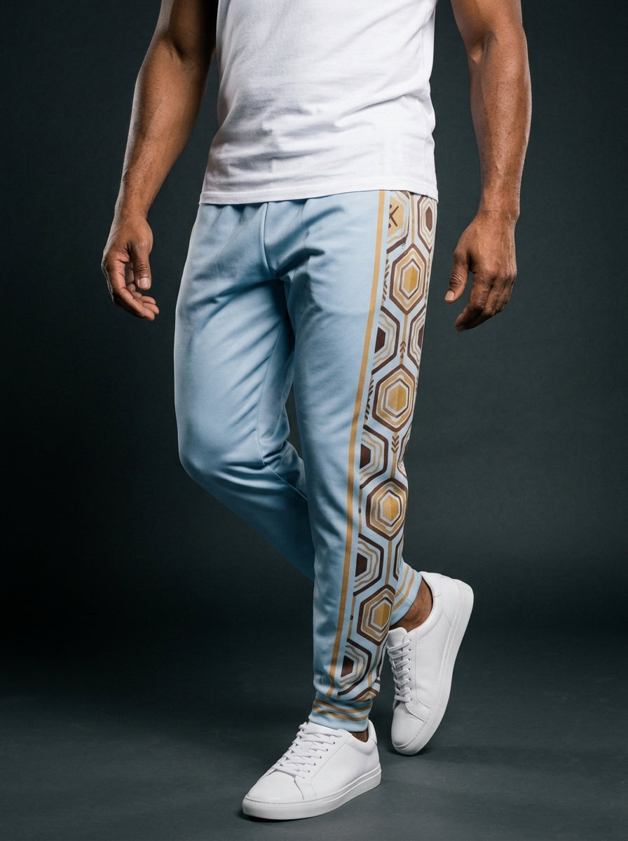AnanseNova™ Men's Joggers in Igwe Blue, front view on model — AnanseNova™ hexagon side-panel stripe edged in bronze pinstripes, striped ribbed ankle cuffs. SunBorn