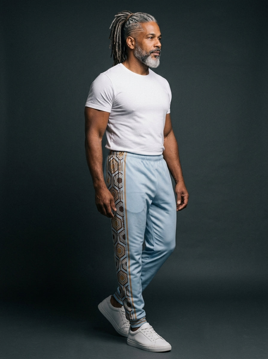AnanseNova™ Men's Joggers in Igwe Blue, three-quarter right view on model — slim tapered leg, striped ribbed ankle cuffs. SunBorn