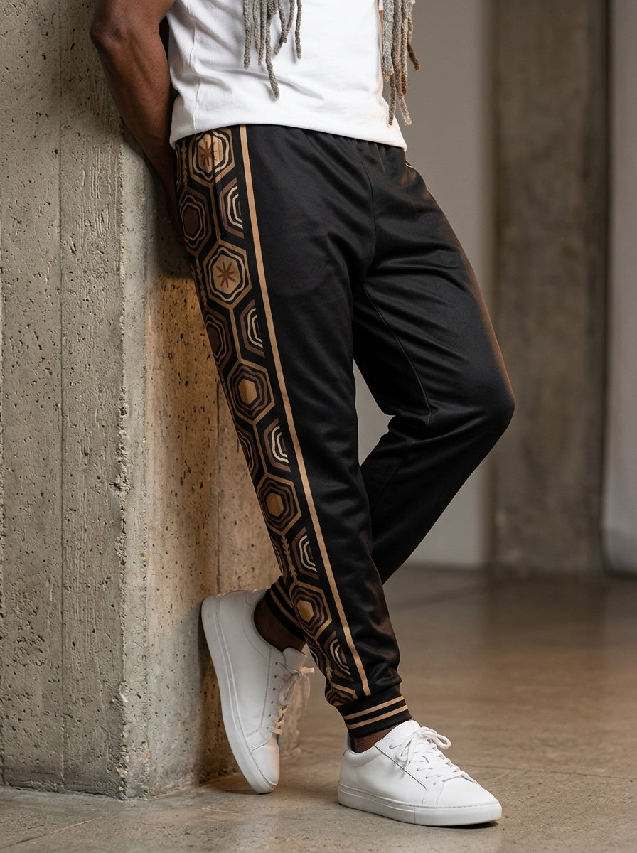 AnanseNova™ Men's Joggers in Oji Black, front view on model — AnanseNova™ hexagon side-panel stripe edged in bronze pinstripes, striped ribbed ankle cuffs. SunBorn