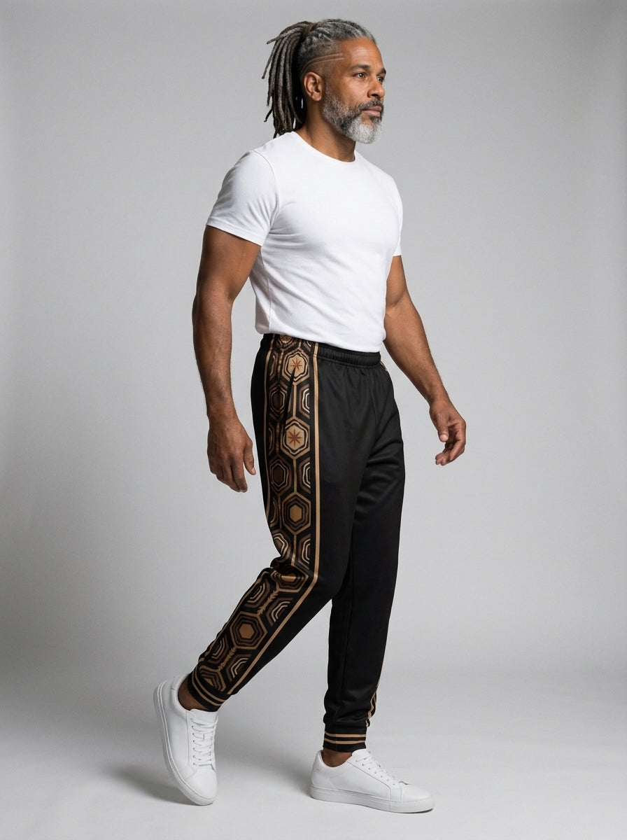 AnanseNova™ Men's Joggers in Oji Black, three-quarter right view on model — slim tapered leg, striped ribbed ankle cuffs. SunBorn
