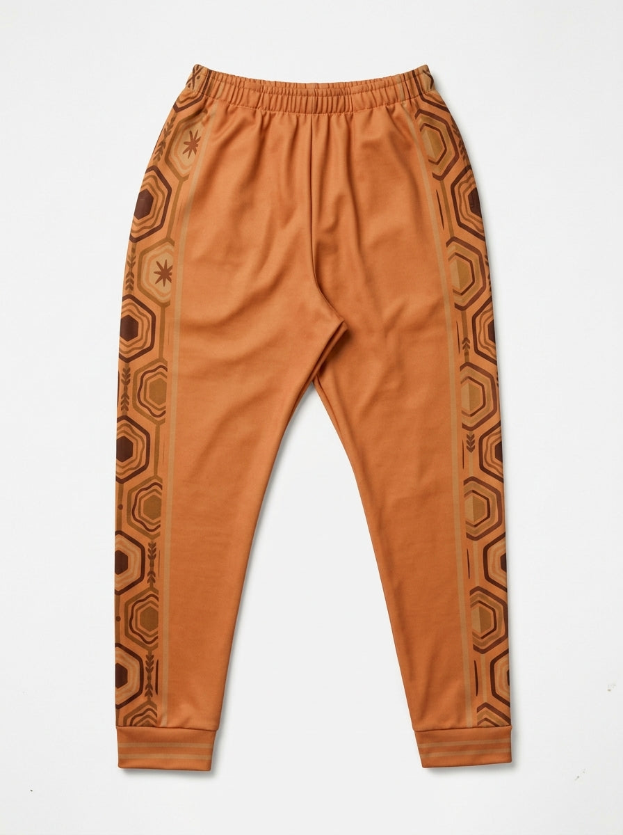 AnanseNova™ Men's Joggers in Sango Orange, flat lay — hexagon side panels on both legs, elastic drawstring waistband. SunBorn