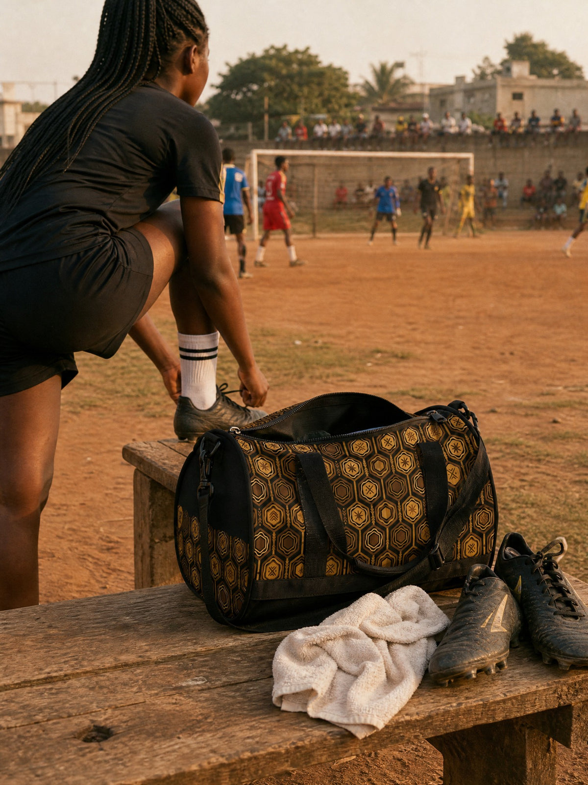 AnanseNova™ Gym Bag on a touchline bench at a football pitch in Accra