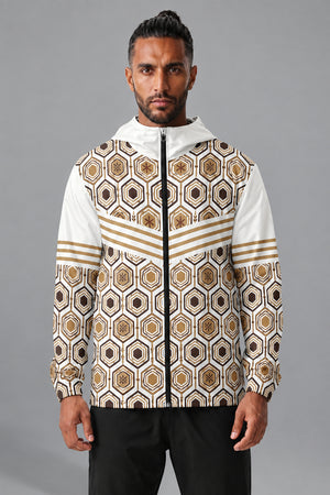 AnanseNova™ Men's Windbreaker in Ocha White — front view on model, AnanseNova™ hexagon all-over print with bronze triple-stripe chevron