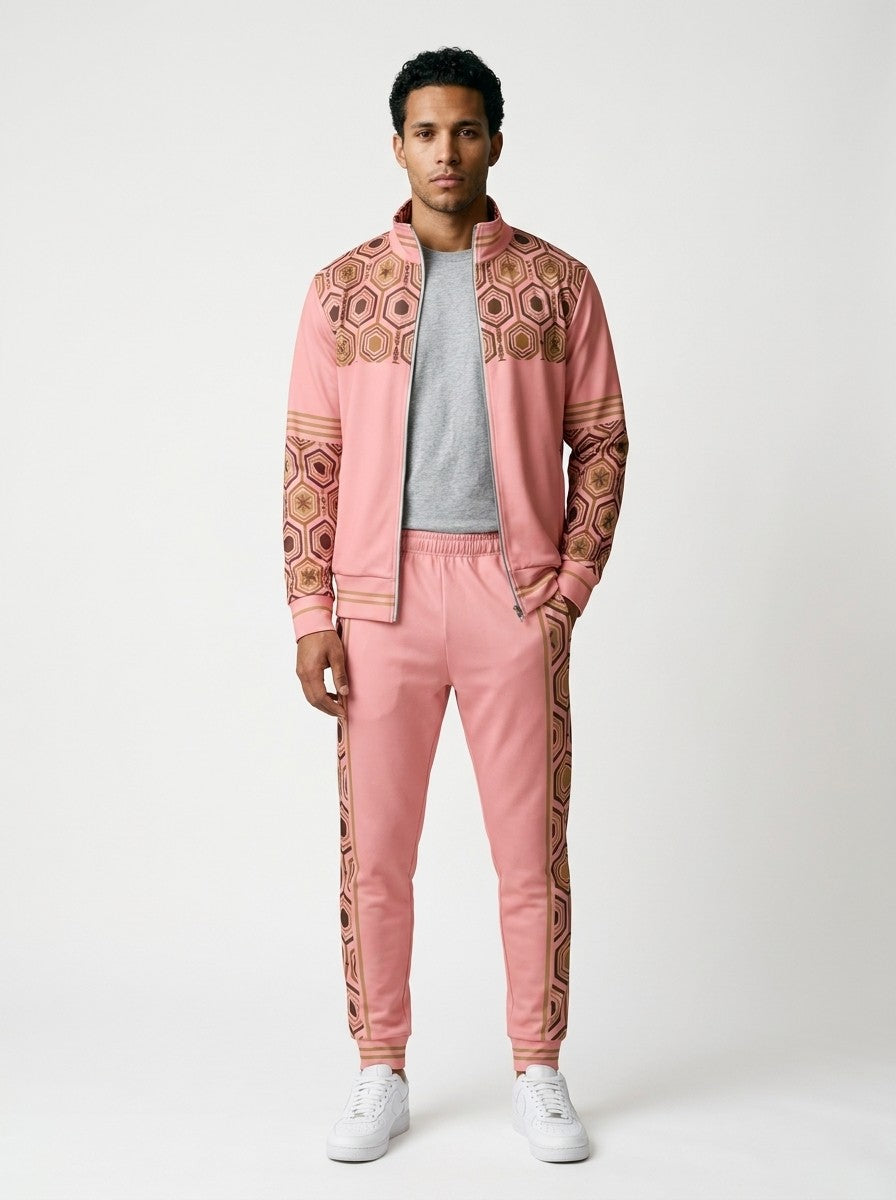 AnanseNova™ Track Jacket + Joggers Set in Eze Pink, front view on model: pink track jacket with brown and gold hexagon print yoke and sleeves, gold sleeve stripes, matching joggers with hex side stripes