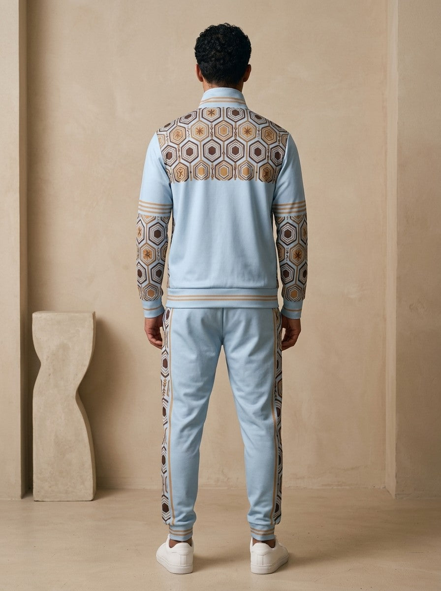 AnanseNova™ Track Jacket + Joggers Set in Igwe Blue, back view on model showing the hexagon print yoke, printed sleeves and jogger side stripes