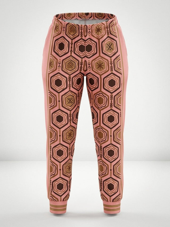 Ghost-mannequin front view of AnanseNova™ Women's Joggers in Adaeze Pink, AnanseNova™ hexagon print across both legs with bronze-striped rib cuffs