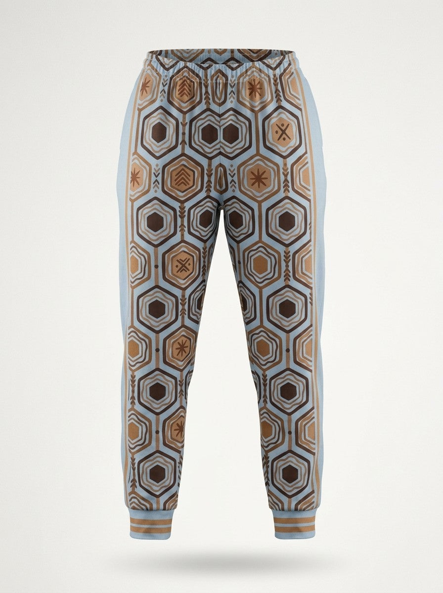 Ghost-mannequin front view of AnanseNova™ Women's Joggers in Igwe Blue, AnanseNova™ hexagon print across both legs with bronze-striped rib cuffs