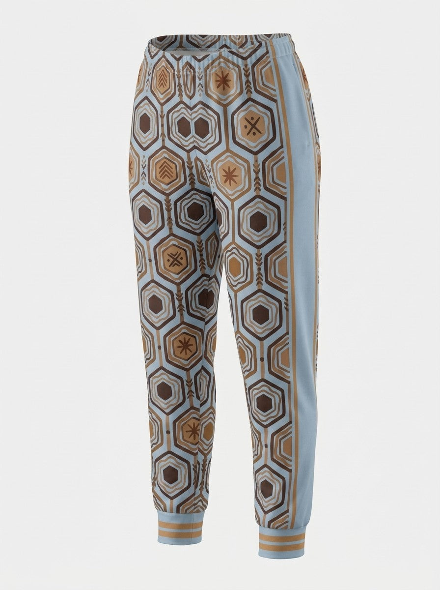 Three-quarter ghost-mannequin view of AnanseNova™ Women's Joggers in Igwe Blue showing the light blue side panel and bronze side stripe